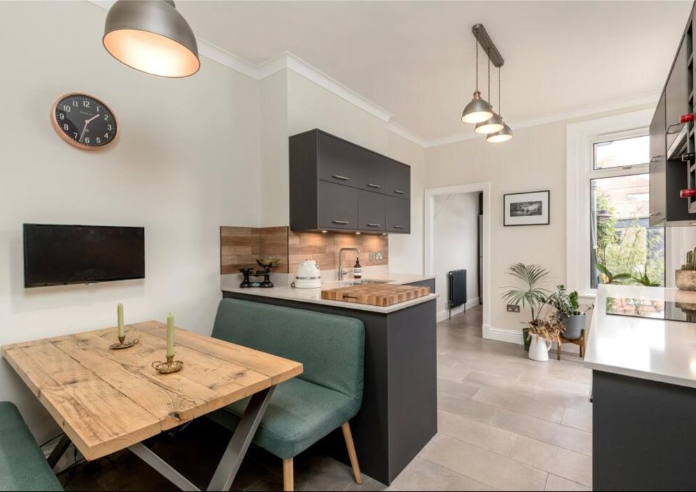 Kitchen peninsula with integrated dining seating at Warriston Grove.